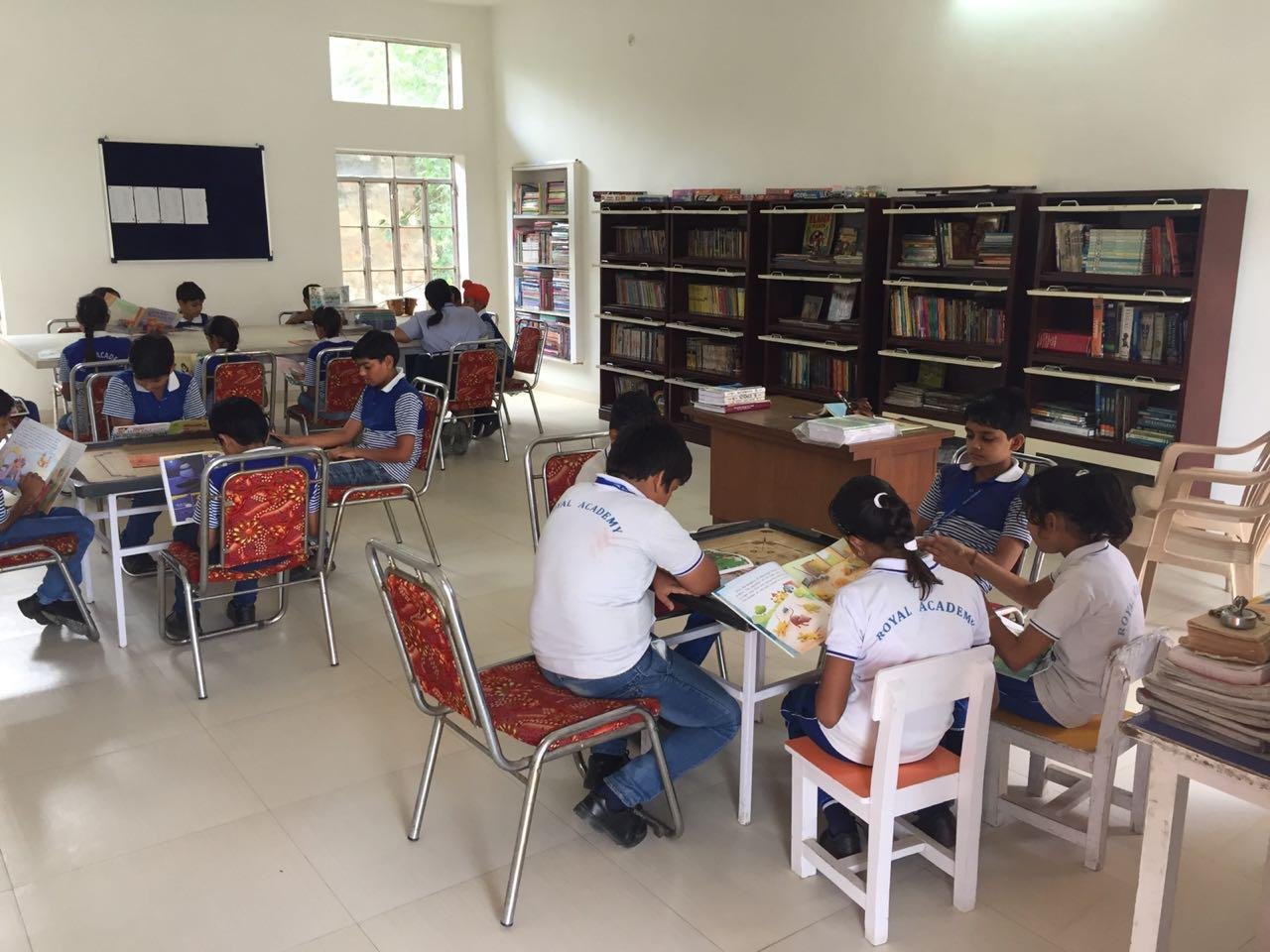 Royal Academy Alwar primary students reading in the school library